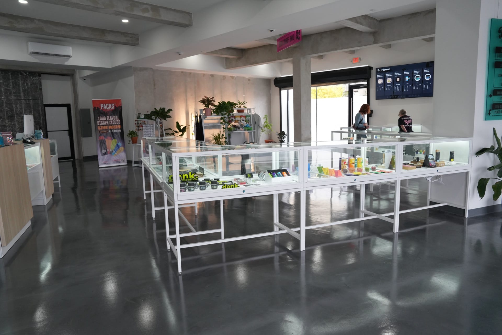 Beleaf Brooklyn dispensary interior with display cases, plants, and polished concrete floor