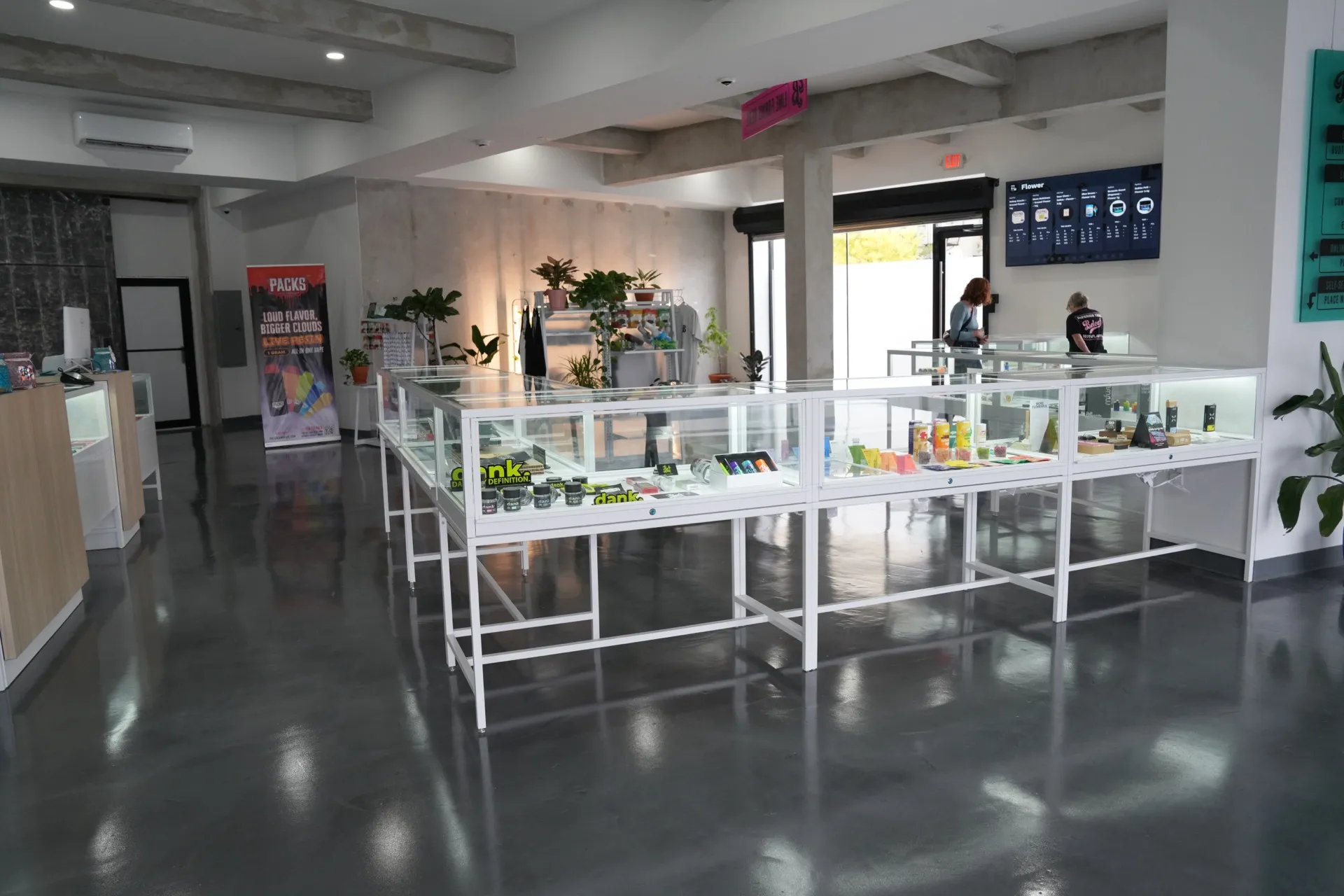 Beleaf Brooklyn dispensary interior with display cases, plants, and polished concrete floor