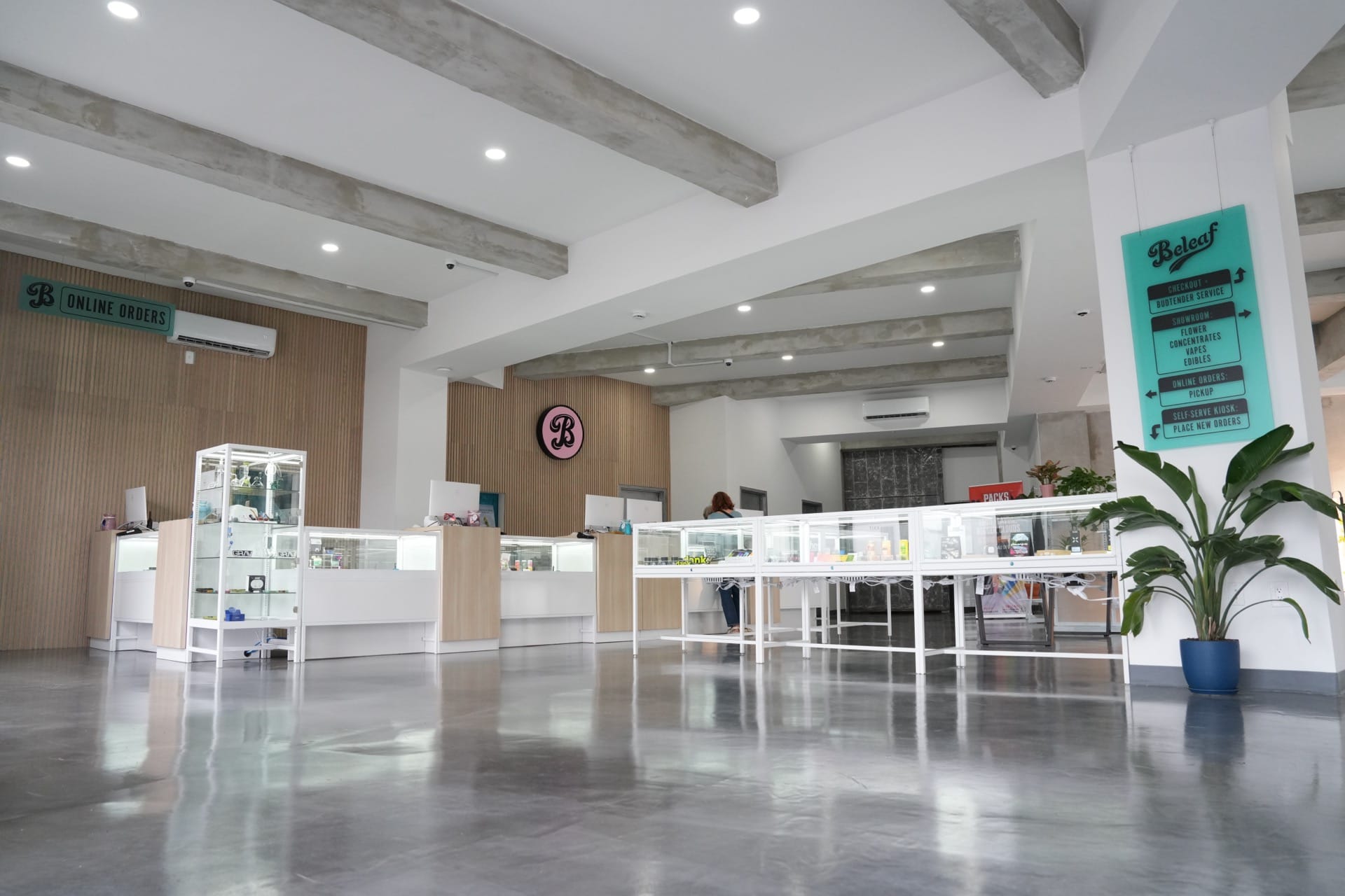 Beleaf Calverton cannabis dispensary interior with budtenders and display cases