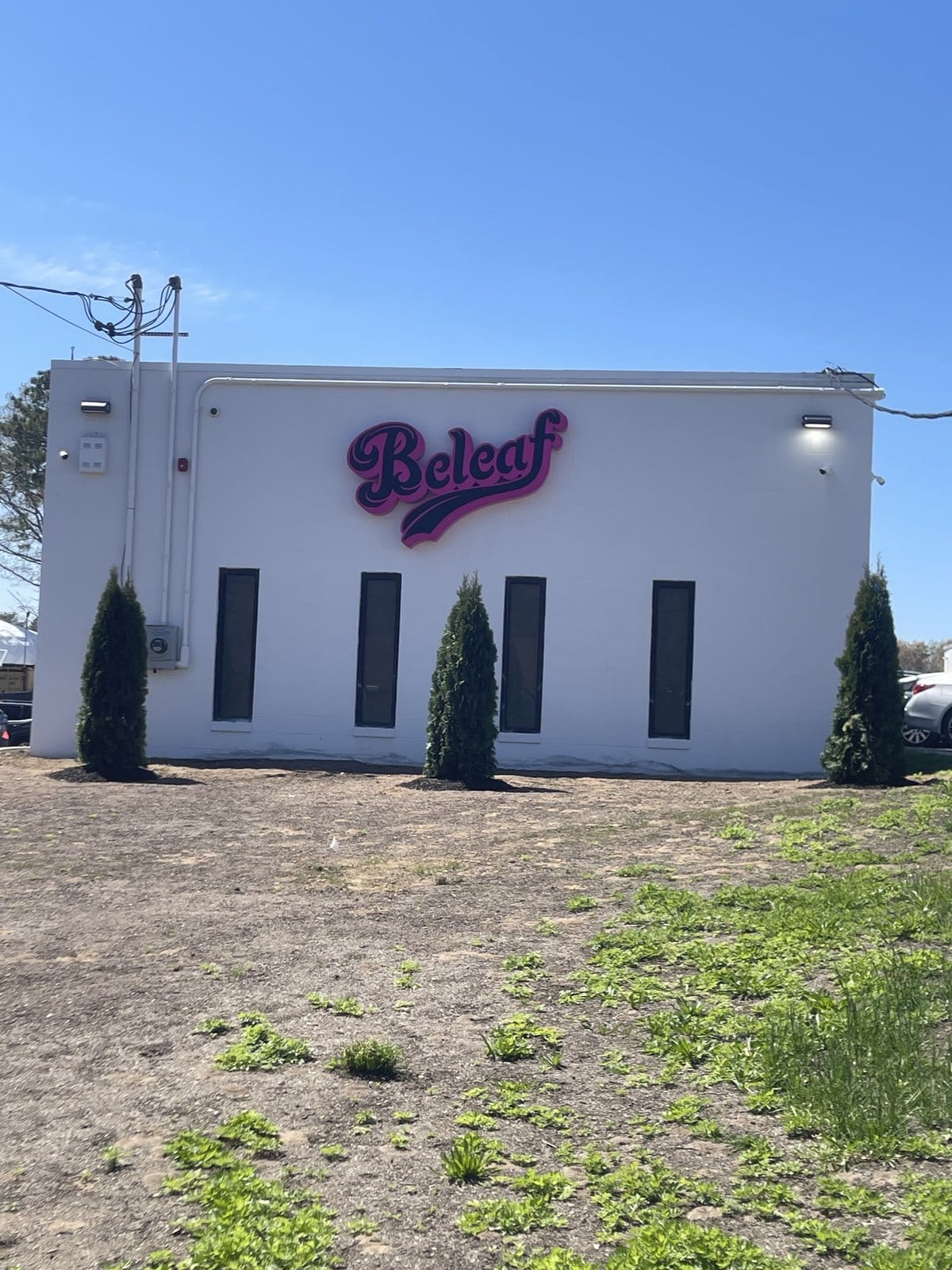 Beleaf Medford storefront at 262 Middle Island Road — pink Beleaf script sign on the white building exterior