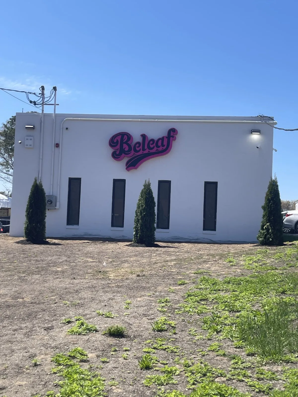 Beleaf Medford storefront at 262 Middle Island Road - pink Beleaf script sign on the white building exterior
